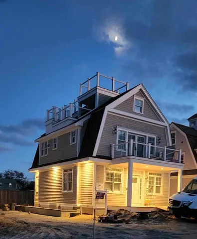 a kitchen with granite countertop white cabinets and a sink