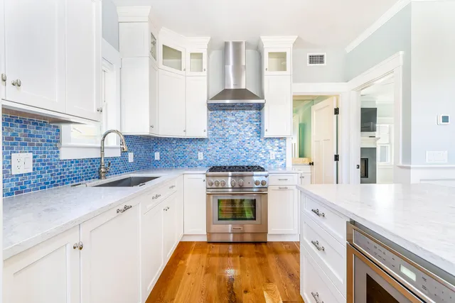 a bathroom with a potted plant on the counter and mirror