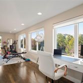 a view of a livingroom with workspace and a window