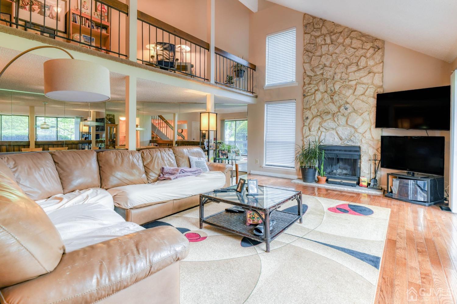 542 Westgate Drive Edison, NJ 08820 - Photo 29 of 30 a living room with furniture a flat screen tv and a fireplace