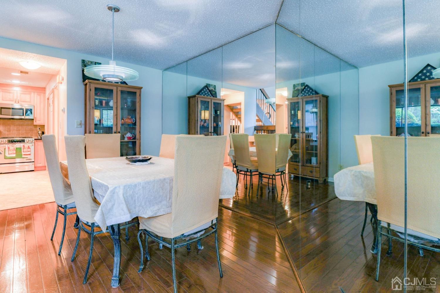 542 Westgate Drive Edison, NJ 08820 - Photo 3 of 30 a dining room with furniture a chandelier and wooden floor