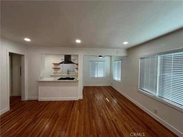 a kitchen with wooden floors and appliances