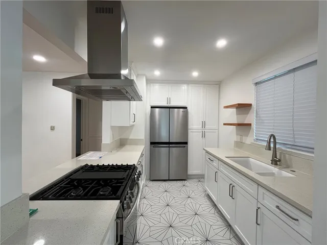 a kitchen with a sink stainless steel appliances and cabinets
