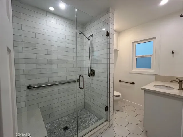a bathroom with a shower and a sink