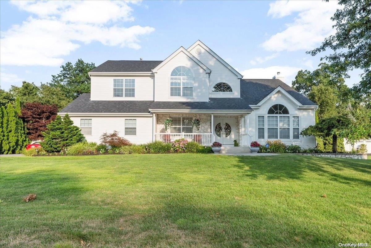 a front view of a house with garden and porch