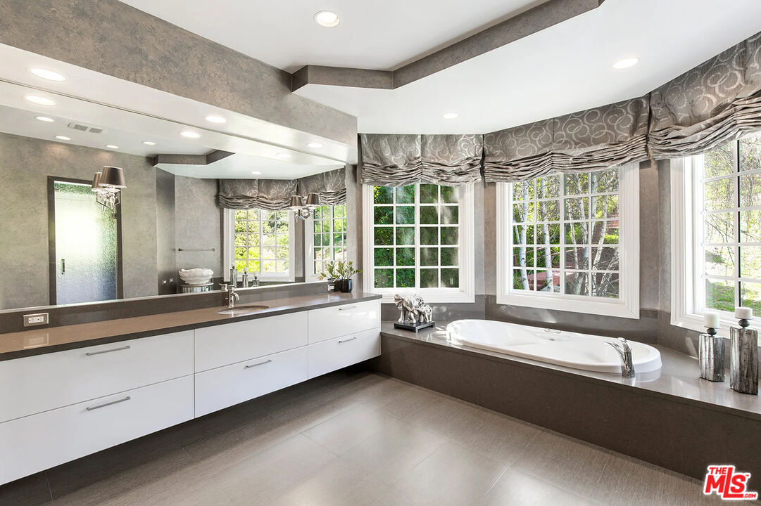 14132 Beresford Road Beverly Hills, CA 90210 - Photo 11 of 21 a large spacious bathroom with a large tub and double vanity