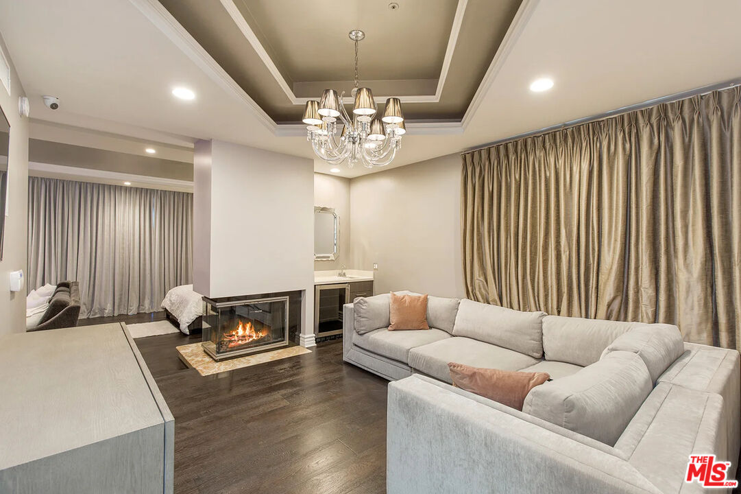 14132 Beresford Road Beverly Hills, CA 90210 - Photo 14 of 21 a living room with furniture and a chandelier