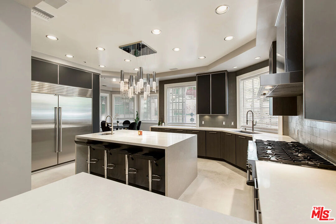 14132 Beresford Road Beverly Hills, CA 90210 - Photo 7 of 21 a kitchen with stainless steel appliances granite countertop a sink and a refrigerator
