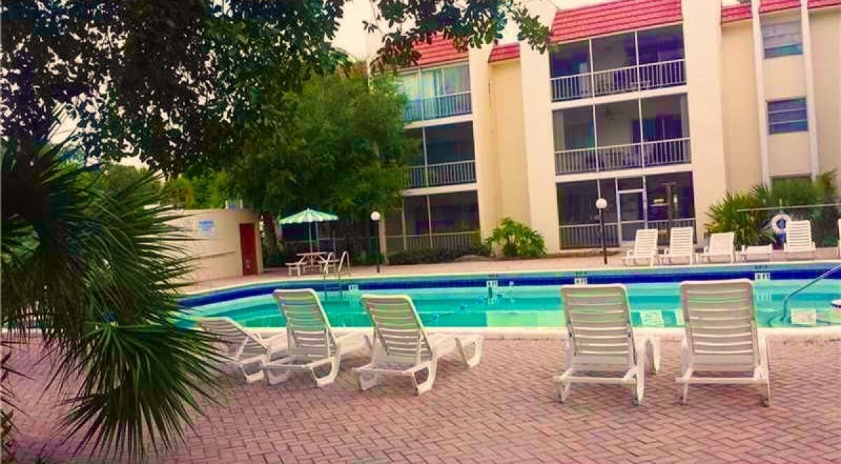 610 Northwest 13th Street, Unit 23 Boca Raton, FL 33486 - Photo 9 of 28 a view of a chairs and table in the patio