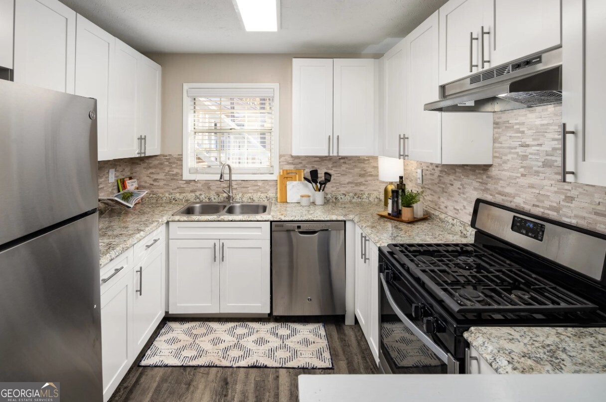 1173 North Hairston Road, Unit 2802 Stone Mountain, GA 30083 - Photo 1 of 31 a kitchen with a sink stove and refrigerator