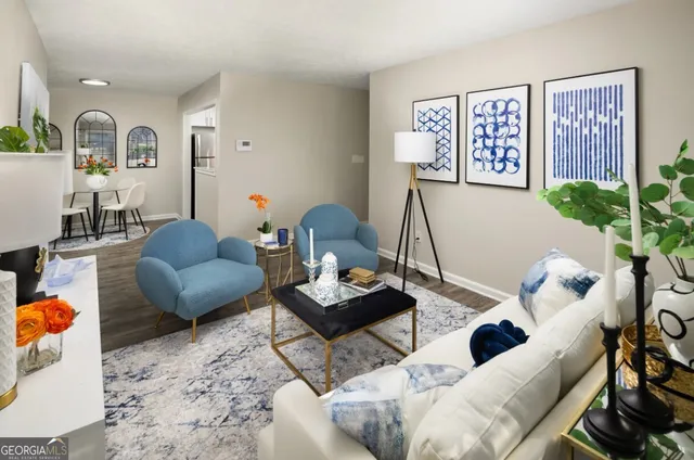 a living room with furniture and wooden floor