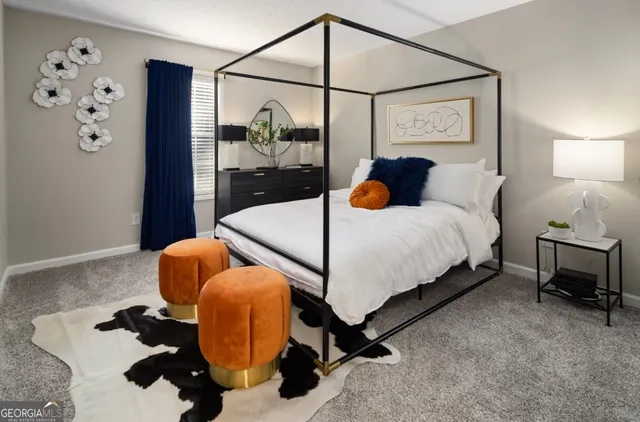 a bedroom with a bed and dresser with mirror