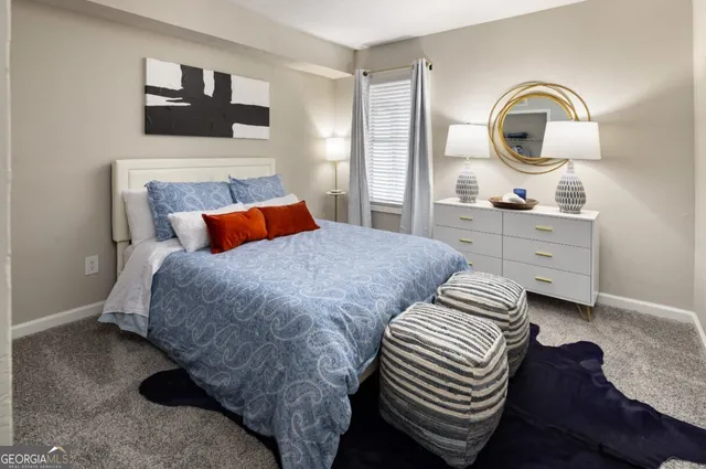 a bedroom with a bed and a dresser