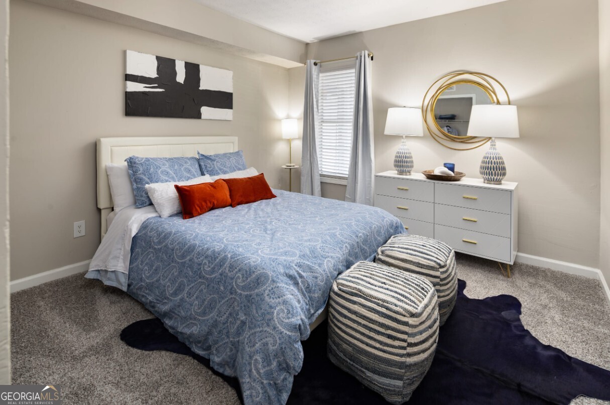 1173 North Hairston Road, Unit 2802 Stone Mountain, GA 30083 - Photo 15 of 31 a bedroom with a bed and a dresser