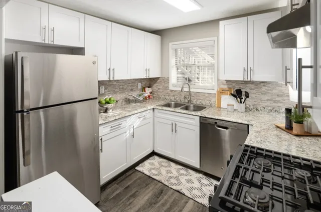 a kitchen with a sink stove and refrigerator