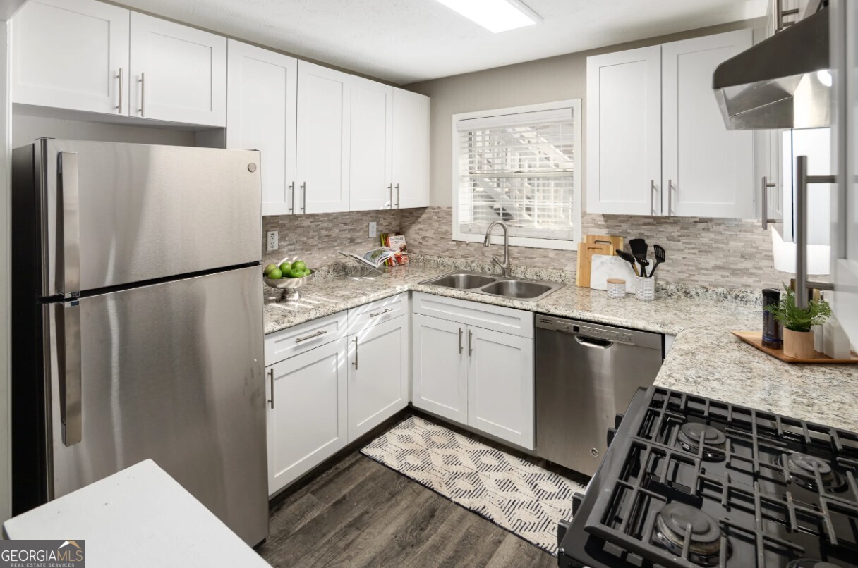 1173 North Hairston Road, Unit 2802 Stone Mountain, GA 30083 - Photo 2 of 31 a kitchen with a sink stove and refrigerator