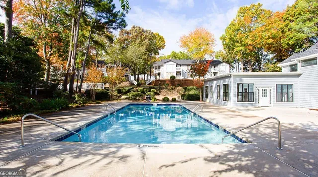 a view of a white house with swimming pool