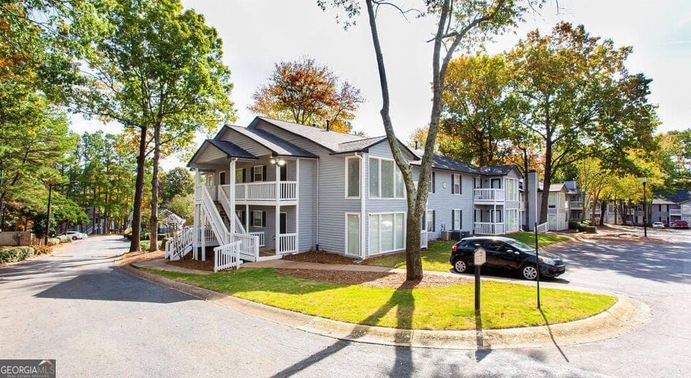 1173 North Hairston Road, Unit 2802 Stone Mountain, GA 30083 - Photo 27 of 31 a view of a swimming pool with a house in the background