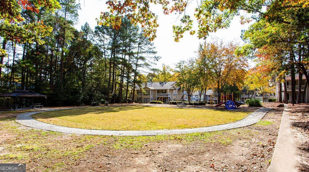 1173 North Hairston Road, Unit 2802 Stone Mountain, GA 30083 - Photo 29 of 31 a view of a swimming pool with an outdoor space and seating area