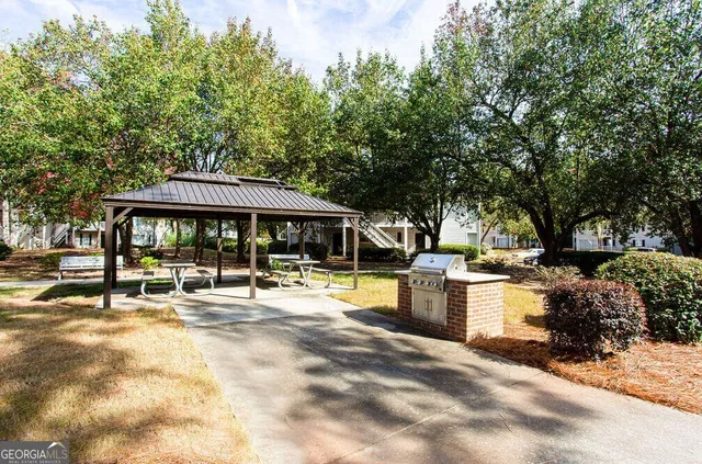 a view of a house with swimming pool and sitting area