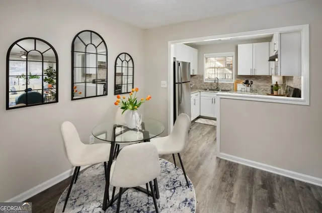 a view of a dining room with furniture and chandelier