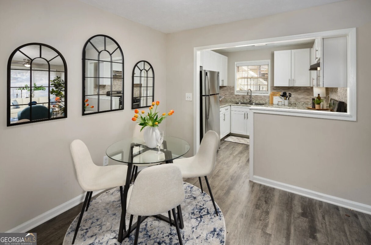 1173 North Hairston Road, Unit 2802 Stone Mountain, GA 30083 - Photo 10 of 31 a view of a dining room with furniture and chandelier