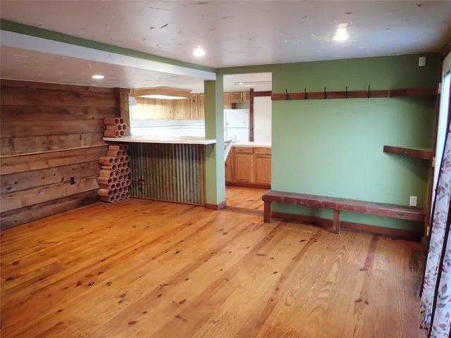 a room with wooden furniture and a window