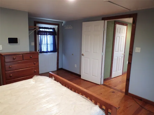 a bed room with a bed and a mirror