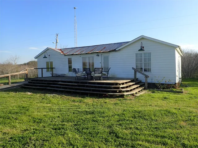a backyard of a house with wooden floor and fence