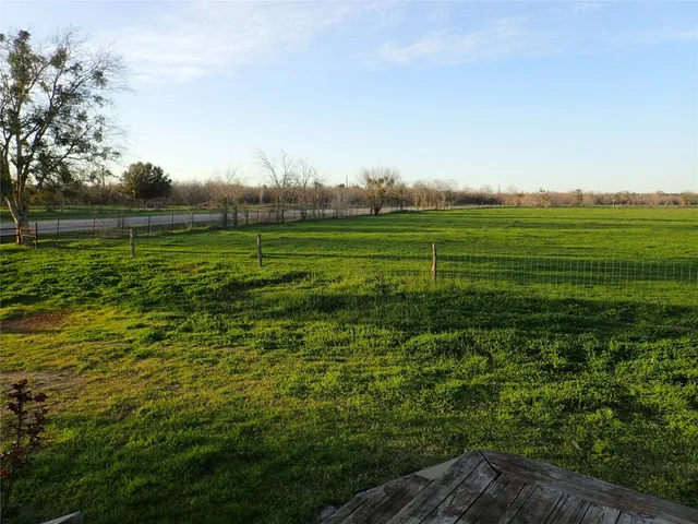 a view of a green field with clear sky