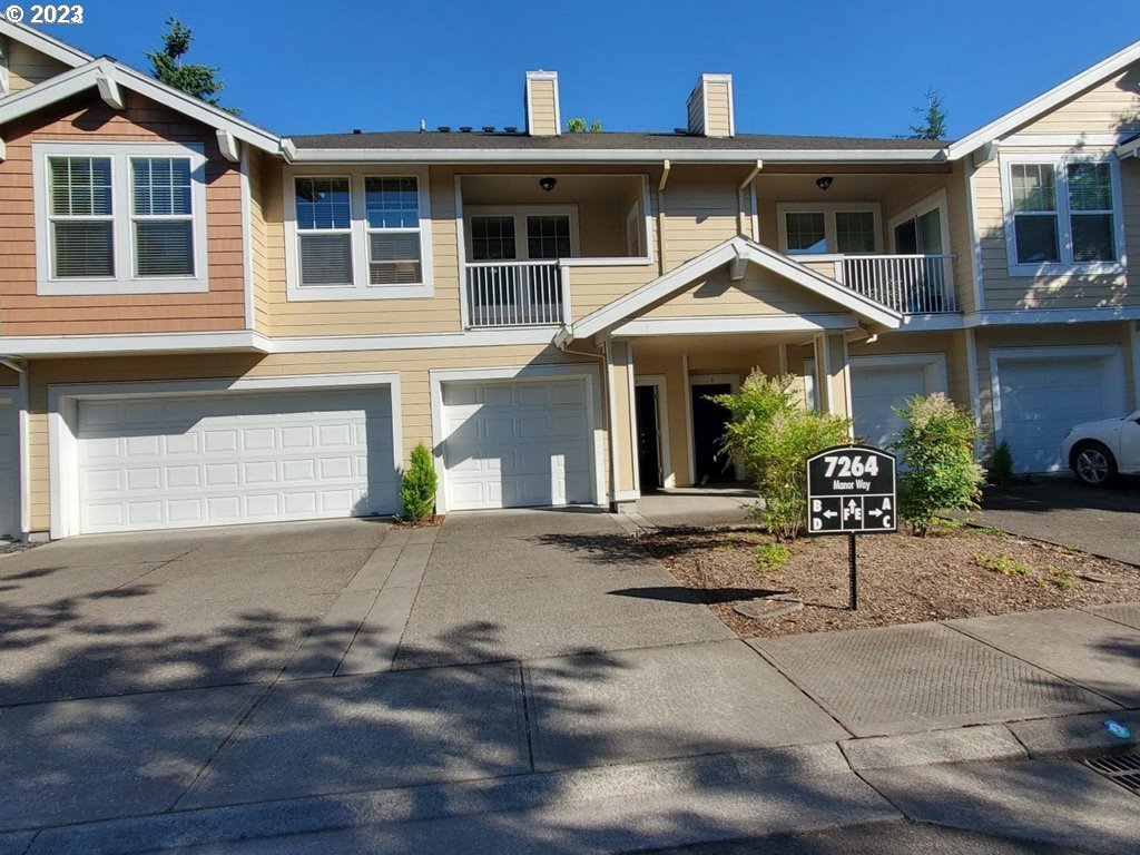 7264 Southwest Manor Way, Unit F Beaverton, OR 97078 - Photo 1 of 1 a front view of a house with a yard and garage
