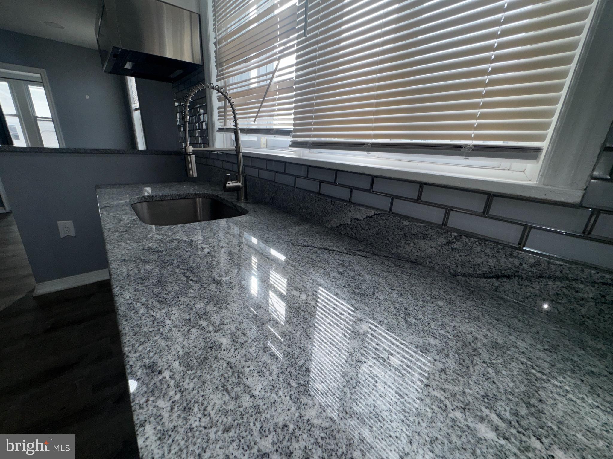 700 Lloyd Street Chester, PA 19013 - Photo 22 of 32 a kitchen with granite countertop a sink and a window