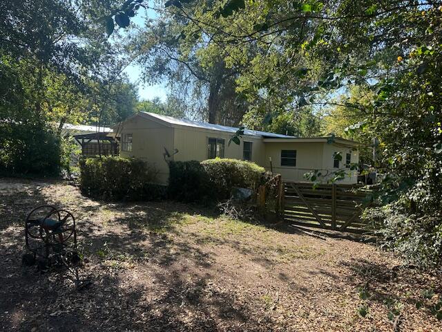 143 West Heather Avenue DeFuniak Springs, FL 32433 - Photo 2 of 20 a backyard of a house with barbeque oven and outdoor seating