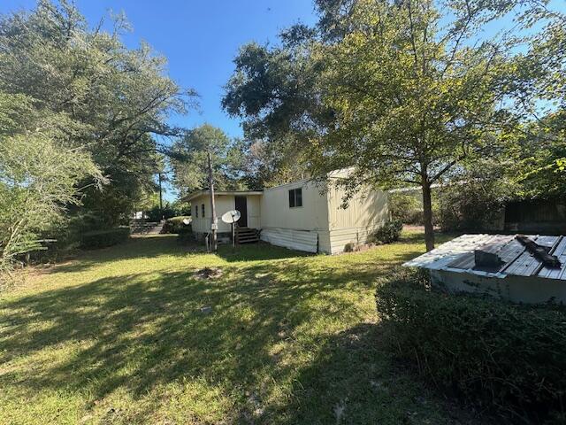 143 West Heather Avenue DeFuniak Springs, FL 32433 - Photo 5 of 20 a backyard of a house with a table and chairs