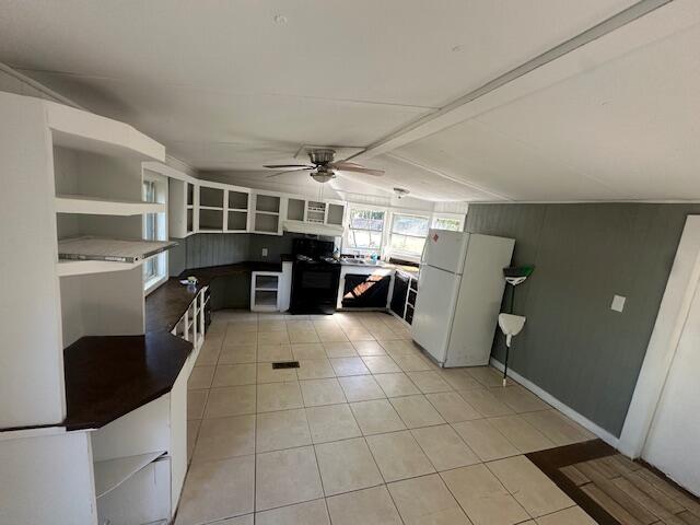 143 West Heather Avenue DeFuniak Springs, FL 32433 - Photo 7 of 20 a view of a kitchen with fridge and furniture