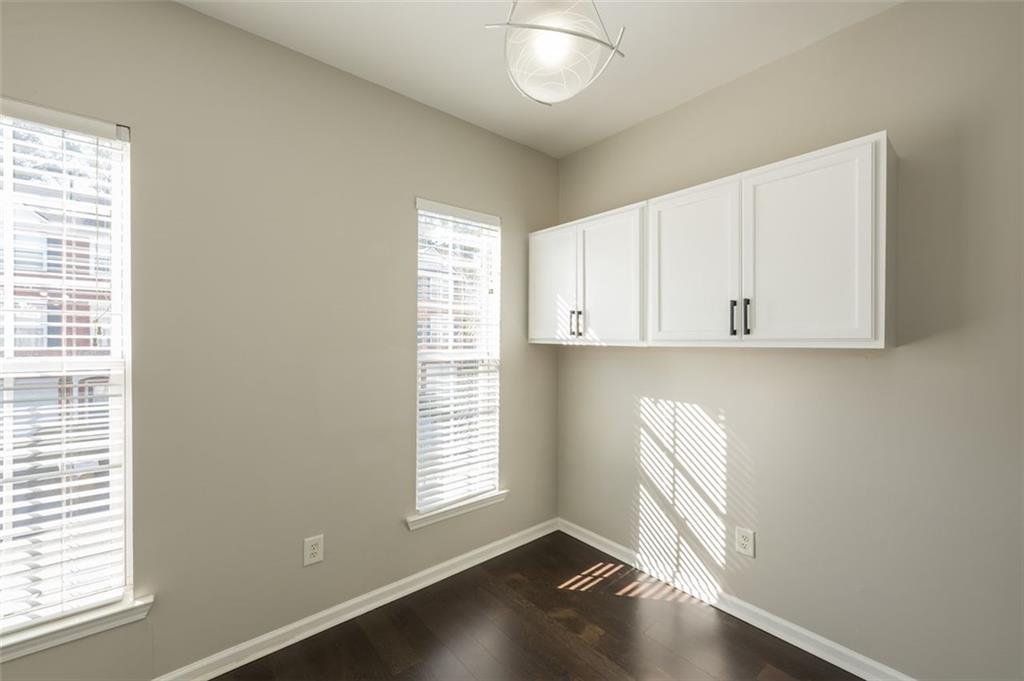 3177 Mill Springs Circle Northeast Buford, GA 30519 - Photo 11 of 27 an empty room with wooden floor and windows
