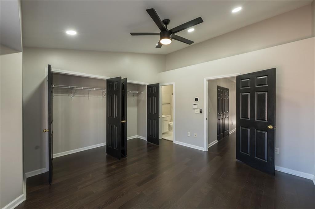 3177 Mill Springs Circle Northeast Buford, GA 30519 - Photo 15 of 27 an empty room with wooden floor and a ceiling fan