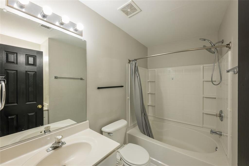 3177 Mill Springs Circle Northeast Buford, GA 30519 - Photo 17 of 27 a bathroom with a bathtub shower sink vanity and toilet