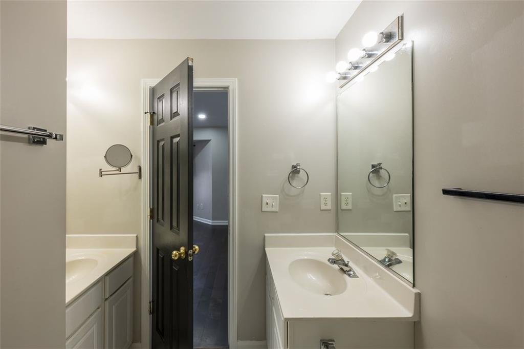 3177 Mill Springs Circle Northeast Buford, GA 30519 - Photo 18 of 27 a bathroom with a shower sink and mirror