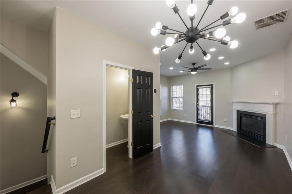 3177 Mill Springs Circle Northeast Buford, GA 30519 - Photo 8 of 27 wooden floor in an empty room with a window