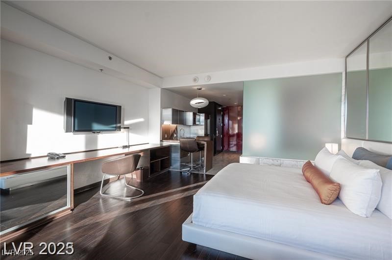 4381 West Flamingo Road, Unit 3303 Las Vegas, NV 89103 - Photo 31 of 37 Bedroom with dark wood finished floors