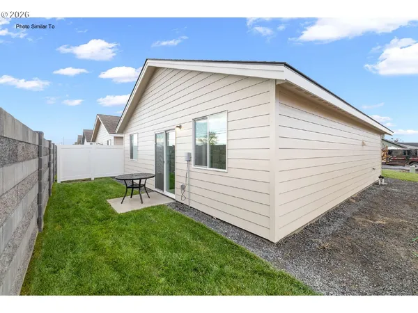 a view of a white house with a yard