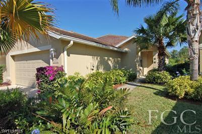 4744 Fairloop Run Lehigh Acres, FL 33973 - Photo 1 of 10 a flower plants in front of a house