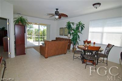 4744 Fairloop Run Lehigh Acres, FL 33973 - Photo 2 of 10 a living room with furniture and a potted plant