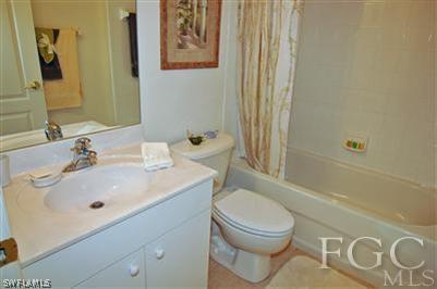 4744 Fairloop Run Lehigh Acres, FL 33973 - Photo 6 of 10 a bathroom with a sink a toilet and shower