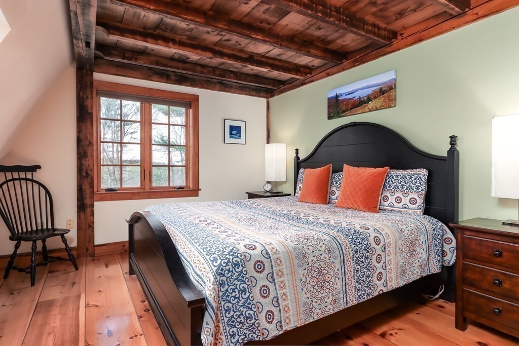 24 Whitney Road Shirley, MA 01464 - Photo 15 of 42 a bedroom with a bed and a dresser next to a window