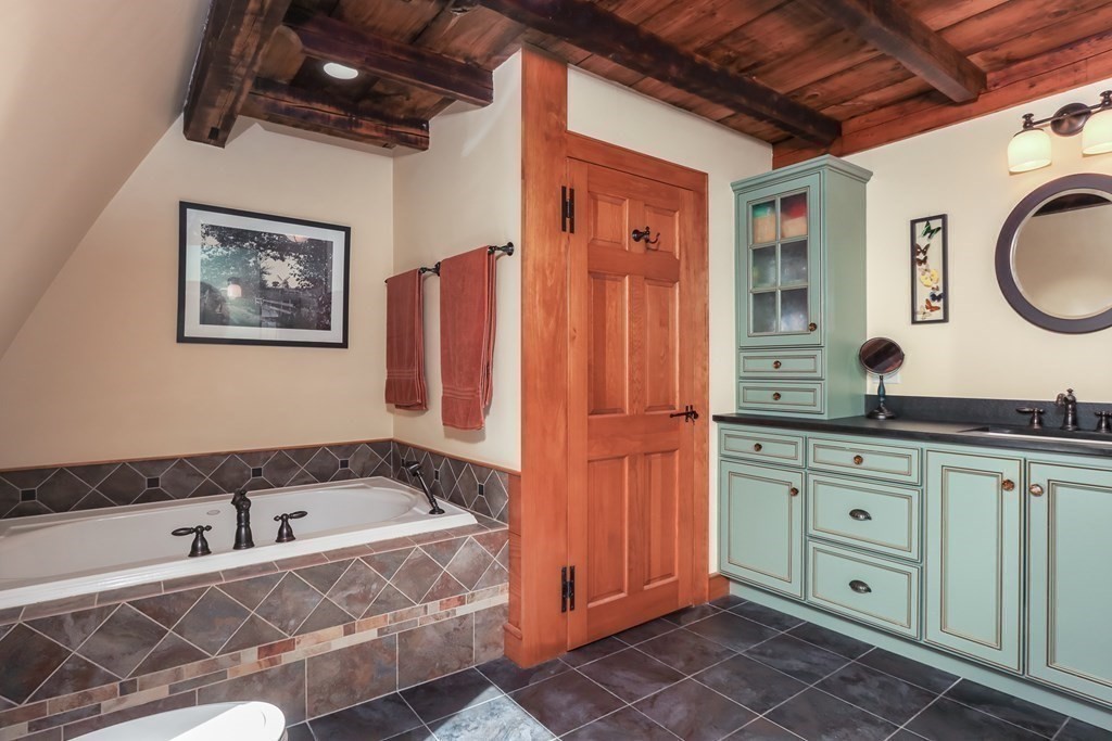 24 Whitney Road Shirley, MA 01464 - Photo 17 of 42 a spacious bathroom with a granite countertop sink and a mirror