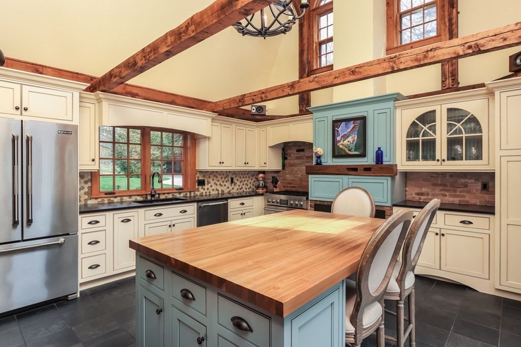 24 Whitney Road Shirley, MA 01464 - Photo 2 of 42 a kitchen with stainless steel appliances kitchen island granite countertop a table chairs in it and wooden floors