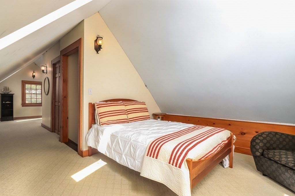 24 Whitney Road Shirley, MA 01464 - Photo 22 of 42 a bedroom with a bed and flowerpot