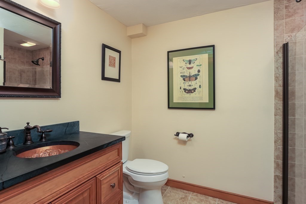 24 Whitney Road Shirley, MA 01464 - Photo 26 of 42 a bathroom with a granite countertop sink and a mirror